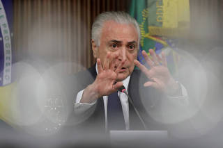 Brazil's President Michel Temer gestures during a meeting with mayors and ministers to discuss public safety at the Planalto Palace in Brasilia