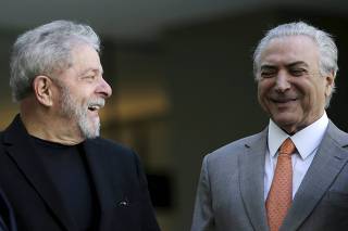 Former Brazilian President Luiz smiles near Brazil's Vice President Temer during a meeting with  other politicians of the Brazilian Democratic Movement Party (PMDB) before a breakfast at the Jaburu Palace in Brasilia