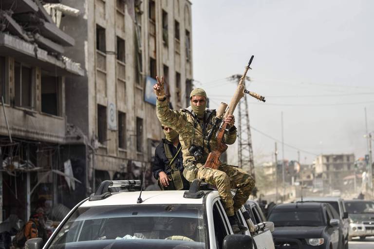 Forças sírias aliadas às milícias turcas comemoram a tomada de controle de Afrin nas ruas da cidade