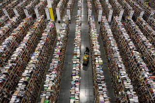 FILE PHOTO: A Worker gathers items for delivery at Amazon's distribution center in Phoenix