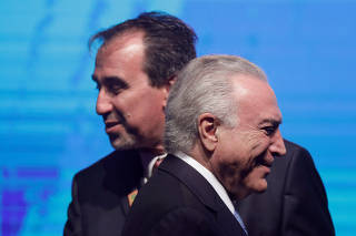 President of the Caixa Economica Federal bank, Gilberto Occhi greets Brazil's President Michel Temer during an event Caixa 2018 of Caixa Economica Federal bank in Brasilia