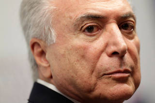 Brazil's President Michel Temer looks on during a ceremony of joining the MDB party by Brazil's Finance Minister Henrique Meirelles, in Brasilia