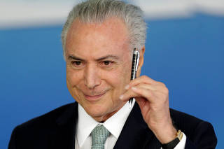 Brazil's President Michel Temer gestures during a ceremony to sanction flexible broadcast schedule of the Voice of Brazil radio program, in Brasilia