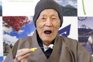 Japanese Masazo Nonaka, who was born 112 years and 259 days ago, eats his favorite cake as he receives a Guinness World Records certificate naming him the world's oldest man during a ceremony in Ashoro