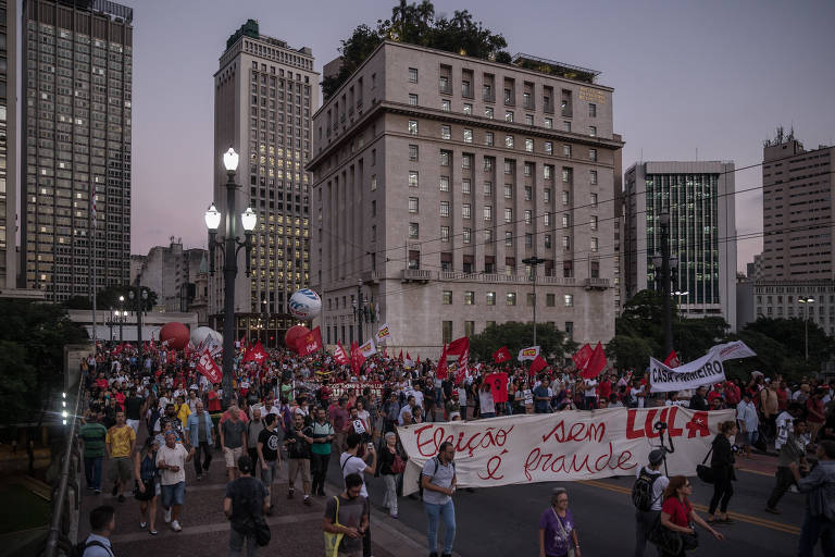Manifestantes pró-Lula (PT) atravessam o viaduto do Chá; ao fundo, o prédio da prefeitura, onde o grupo parou e vaiou o ex-prefeito João Doria (PSDB)
