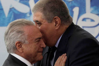 Brazil's President Michel Temer talks with Brazil's Minister of the Government Secretariat Carlos Marun during a ceremony to announce the decree regulating the National Youth System (Sinajuve), at the Planalto Palace in Brasilia