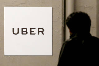 FILE PHOTO: A man arrives at the Uber offices in Queens