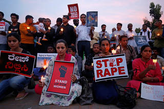 People participate in a candle light vigil as they protest against the rape of an eight-year-old girl in Kathua near Jammu, and a teenager in Unnao, Uttar Pradesh state, in Bengaluru