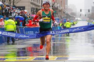 Yuki Kawauchi of Japan crosses the finish line to win the men's division of the 122nd Boston Marathon in Boston