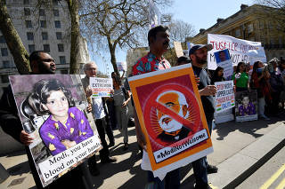 Demonstrators stage a protest against the visit by India's Prime Minister Narendra Modi opposite Downing Street in London