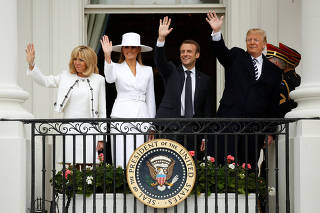 U.S. President Donald Trump and first lady Melania Trump welcome French President Emmanuel Macron and his wife Brigitte Macron during an arrival ceremony at the White House in Washington