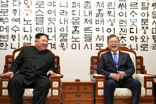 South Korean President Moon Jae-in talks with North Korean leader Kim Jong Un during their meeting at the Peace House at the truce village of Panmunjom