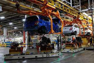 Automated Guided Vehicles carry the chassis for 2018 Chevrolet Sonic vehicles on the assembly line at General Motors Orion Assembly in Lake Orion,