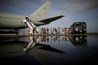 Venezuelan refugees board a Brazilian Air Force plane, heading to Manaus and Sao Paulo, at Boa Vista Airport