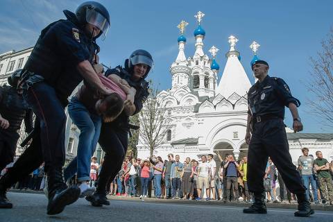 TOPSHOT - Russian police officers detain a protester during an unauthorized anti-Putin rally called by opposition leader Alexei Navalny on May 5, 2018 in Moscow, two days ahead of Vladimir Putin's inauguration for a fourth Kremlin term.
 / AFP PHOTO / Maxim ZMEYEV