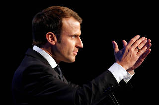 FILE PHOTO: French President Emmanuel Macron delivers a speech during the AMF congress, the annual meeting of French mayors, in Paris