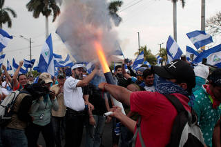 A demonstrator fires a homemade mortar during protest march against Nicaraguan President Daniel Ortega's government in Managua
