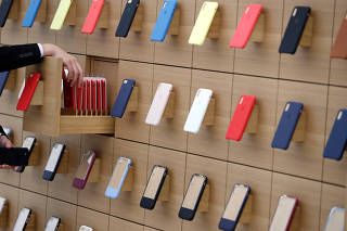 iPhone cases are displayed on a wall at the Apple Shinjuku store in Tokyo