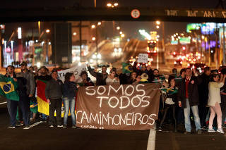 People attend a protest in support of the truck drivers' strike in Canoas,