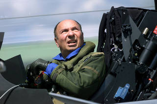 France's Serge Dassault head of Dassault Aviation reacts as he stands in the cockpit of a french made Rafale after arriving from the southern city of Istres, at Le Bourget
