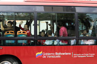 A group of opposition activists jailed for protesting against President Nicolas Maduro arrive on a bus to a detention centre of the Bolivarian National Intelligence Service (SEBIN) in Caracas