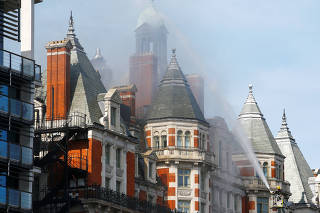 Firefighters tackle a blaze at the Mandarin Oriental Hotel in Knightsbridge, central London