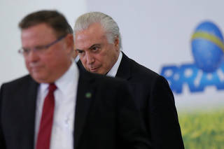 Brazil's President Michel Temer is seen behind the Agriculture Minister Blairo Maggi during the launch ceremony of the Plano Safra 2018/2019, action plan for the agricultural sector, in Brasilia