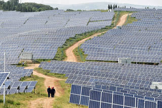 Solar panels are seen at a solar power plant in Pingdingshan