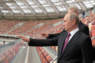 FILE PHOTO: Russian President Putin listens to Moscow Mayor Sobyanin as they inspect the Luzhniki Stadium in Moscow