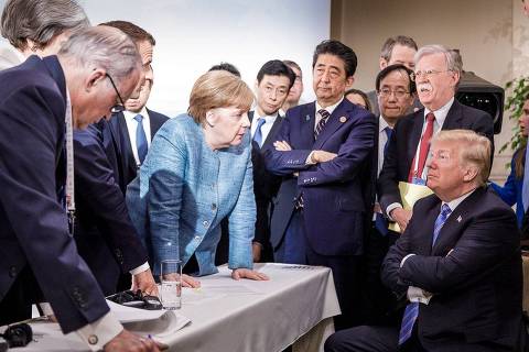 TOPSHOT - Photo released on Twitter by the German Governments spokesman Steffen Seibert on June 9, 2018 and taken by the German government's photographer Jesco Denzel shows US President Donald Trump (R) talking with German Chancellor Angela Merkel (C) and surrounded by other G7 leaders during a meeting of the G7 Summit in La Malbaie, Quebec, Canada.
The photo went viral, popping up all over social media, sometimes in its original form sometimes altered for humorous or satirical ends. / AFP PHOTO / Bundesregierung / Jesco DENZEL / RESTRICTED TO EDITORIAL USE - MANDATORY CREDIT