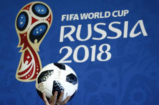 FILE PHOTO: A presenter holds the official match ball for the 2018 FIFA World Cup Russia during an event to announce the new 2018 FIFA Fan Fest Ambassadors in Moscow