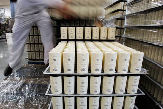 FILE PHOTO: A worker handles cosmetic products at Natura's factory in Cajamar, Sao Paulo