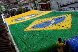 Resident prepares Third Street which is decorated for the 2018 World Cup celebrations, in Manaus