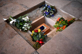 Flowers are placed alongside the ashes of British scientist Stephen Hawking at the site of interment in the nave of the Abbey church, during a memorial service at Westminster Abbey, in London