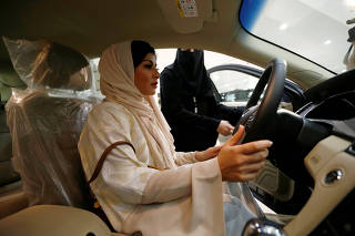 Saudi female surgeon Fatima al-Nasseralah checks her future car at Riyadh's showroom ahead of being able to practice the right to drive in the conservative kingdom later this month