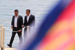 Macedonian PM Zaev and Greek PM Tsipras after the signing of an accord to settle a long dispute over name of the Republic of Macedonia, in the village of Otesevo