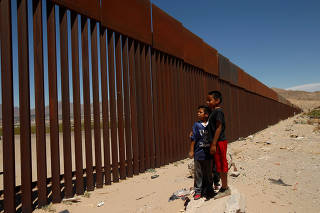 Children stand by a new section of the border wall on the U.S.-Mexico border in this picture taken from Anapra neighborhood in Ciudad Juarez