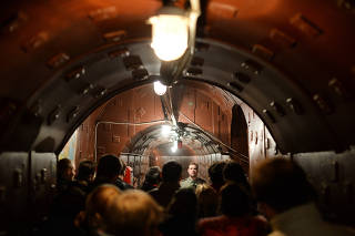 Visitors stand in one of the corridors of Bunker-42, a Soviet era underground bunker and now a museum about the Cold War.
