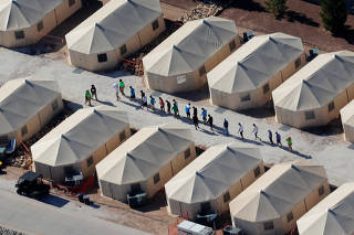 Immigrant children now housed in a tent encampment under the new 