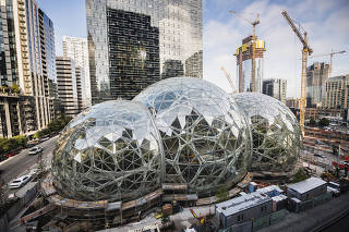 Amazon Tower II rises above the Amazon Biospheres in Seattle.