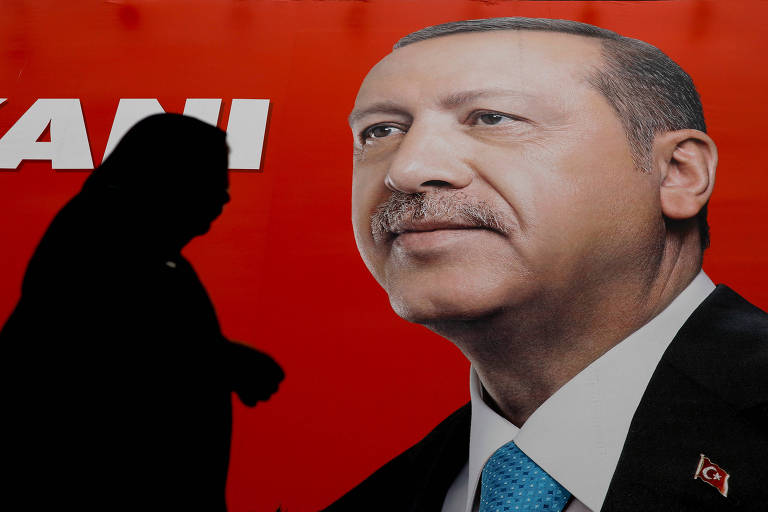 A sombra da mulher aparece à esquerda do cartaz de fundo vermelho, enquanto o rosto de Erdogan está à direita