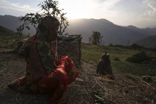 Mansara Nepali sits near her family?s chhaupadi hut, where women are banished when they get their menstrual periods, in the village of Padi, Nepal.