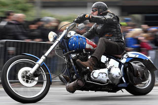 A biker rides his Harley-Davidson during a parade at the 