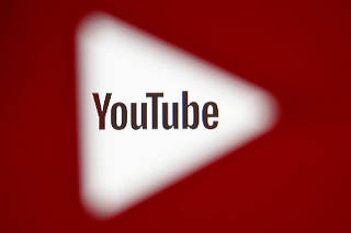 FILE PHOTO:    A 3D-printed YouTube icon is seen in front of a displayed YouTube logo in this illustration