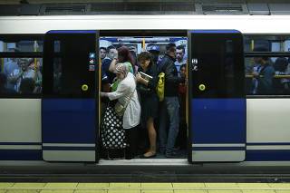 Passengers stand inside a metro during a strike in Madrid