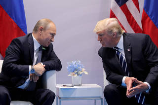FILE PHOTO: Russia's President Putin talks to U.S. President Trump during their bilateral meeting at the G20 summit in Hamburg