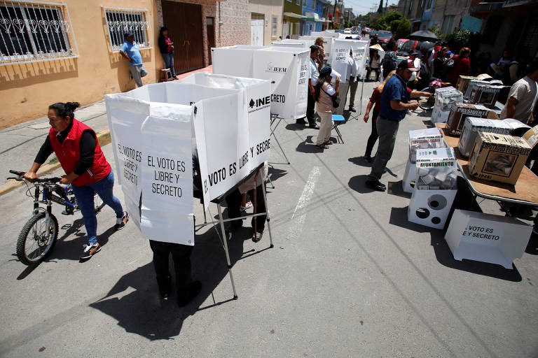 Eleitores em cabines de votação na periferia da Cidade do México