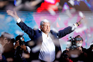 Presidential candidate Andres Manuel Lopez Obrador gestures as he addresses supporters after polls closed in the presidential election, in Mexico City