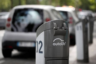 An Autolib' electric car-sharing logo sits at an Autolib' charging station in Paris