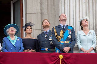 Britain's Queen Elizabeth is joined by members of the Royal Family on the balcony of Buckingham Palace as they watch a fly past to mark the centenary of the Royal Air Force in central London